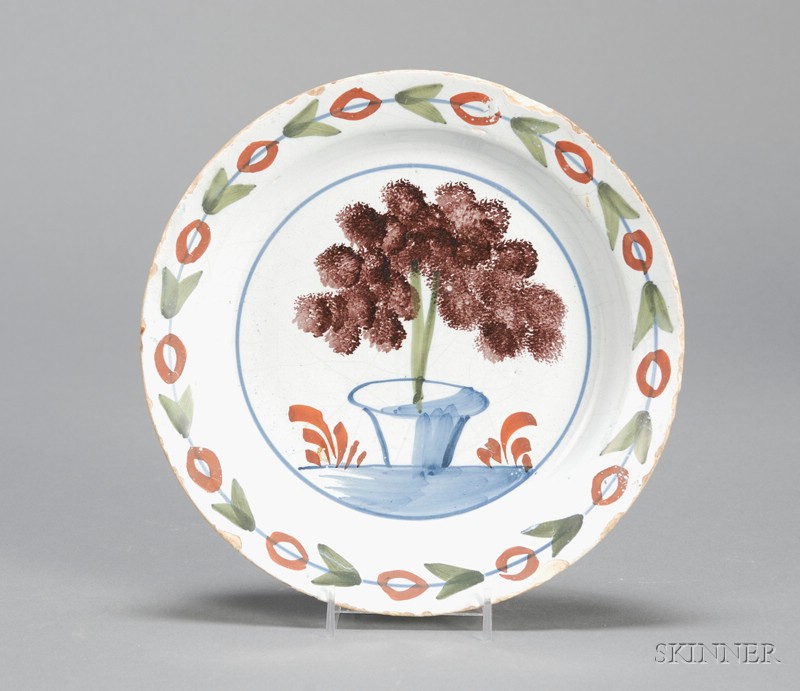 Appraisal: Polychrome Delftware Plate England c central potted tree design with