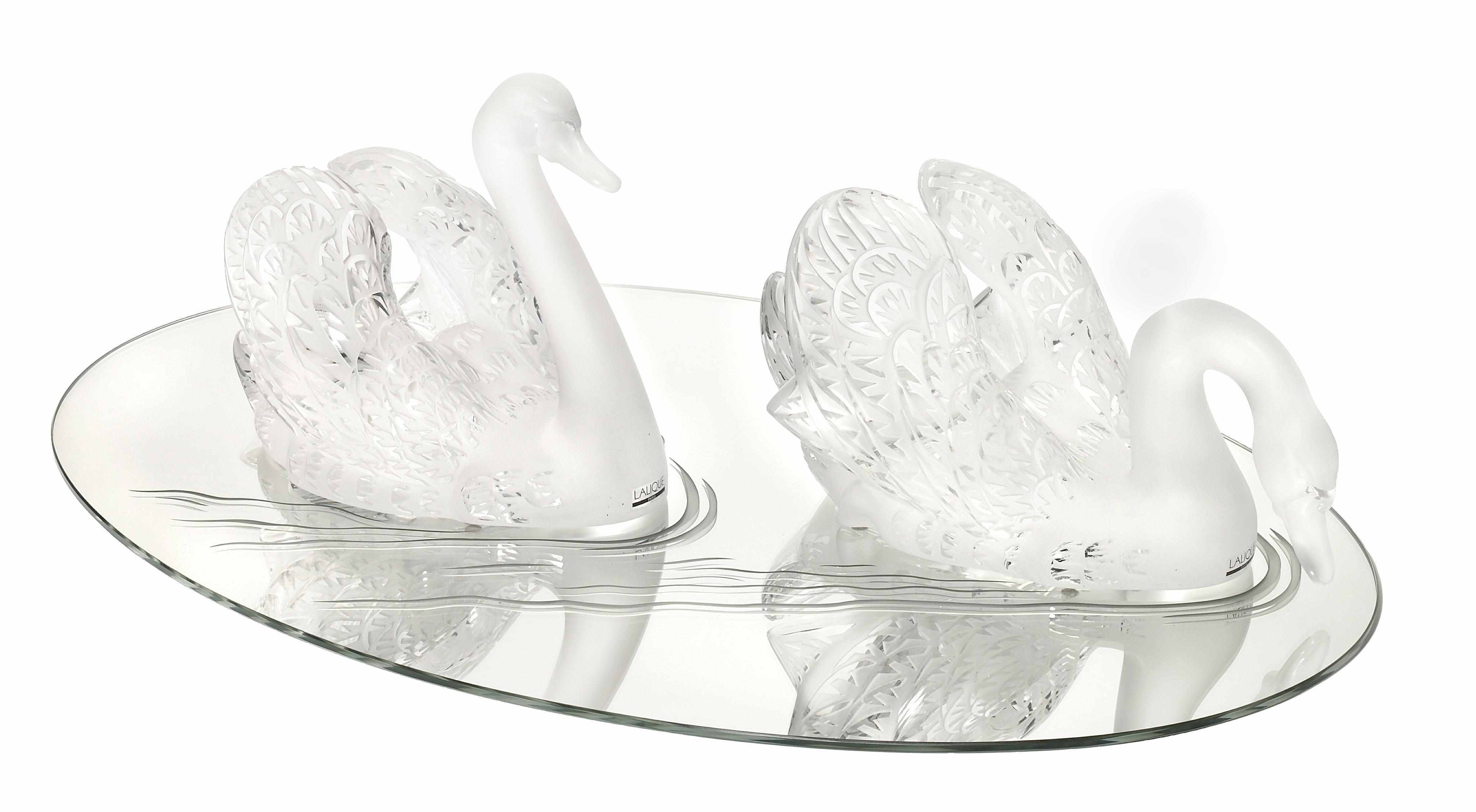 Appraisal: A pair of Lalique clear and frosted glass swans on