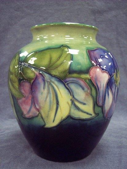 Appraisal: A Clematis pattern spherical vase of green ground cm high