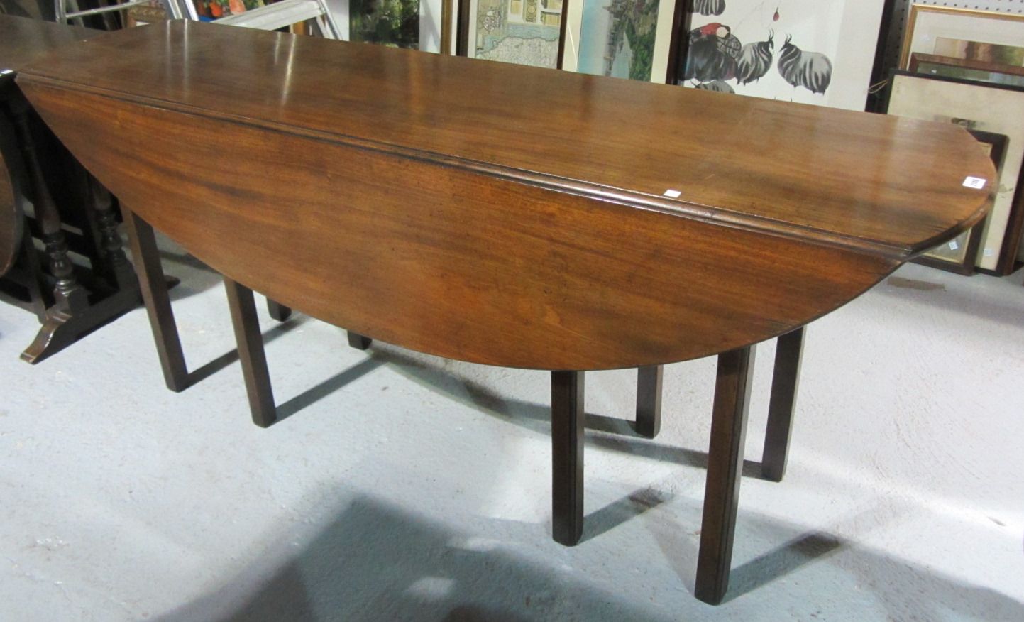 Appraisal: An th century style mahogany oval drop flap wake table