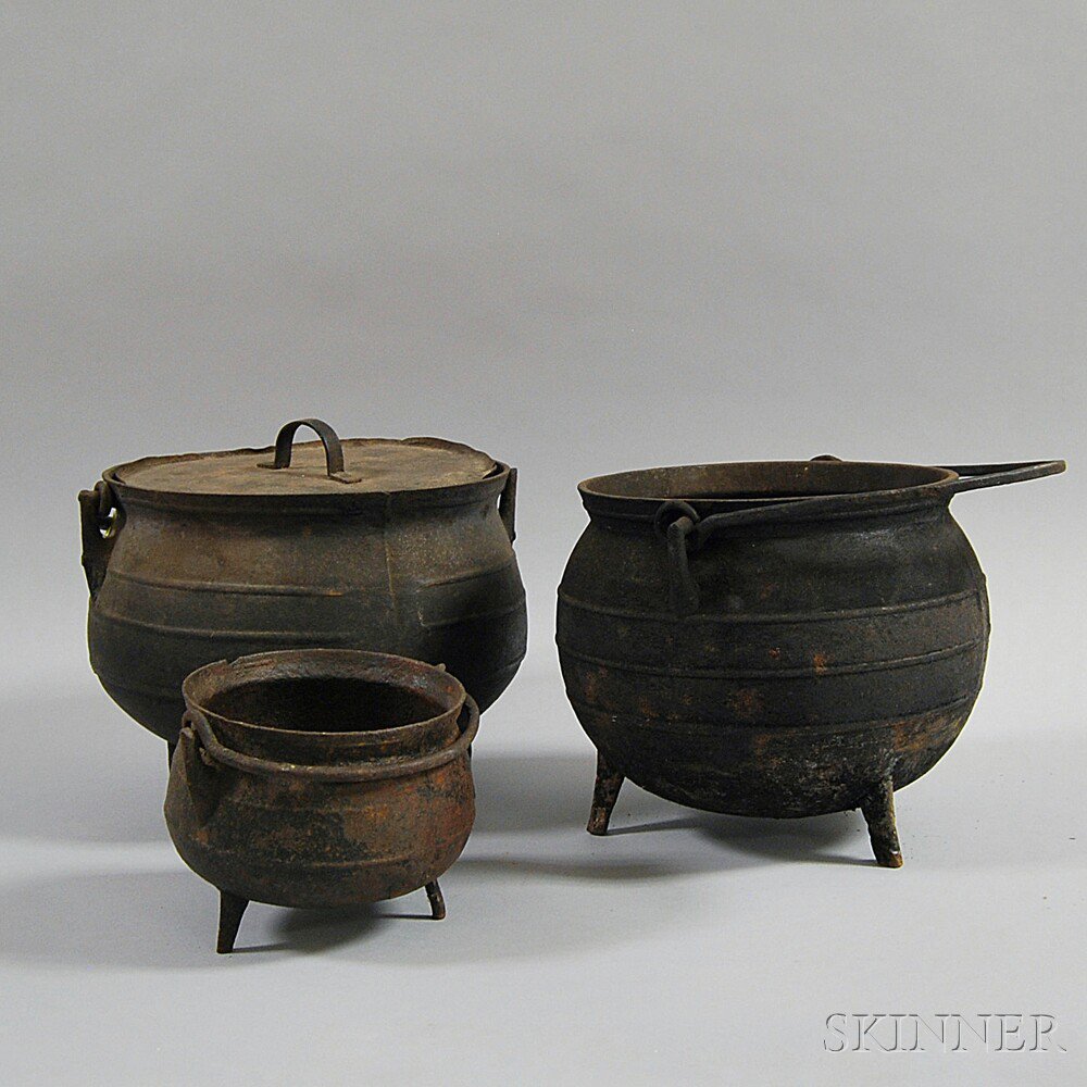 Appraisal: Three Cast Iron Pots th century the round-bellied pots on