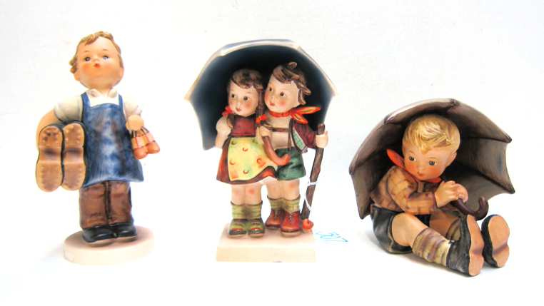 Appraisal: THREE GERMAN HUMMEL FIGURINES of soft paste porcelain Stormy Weather