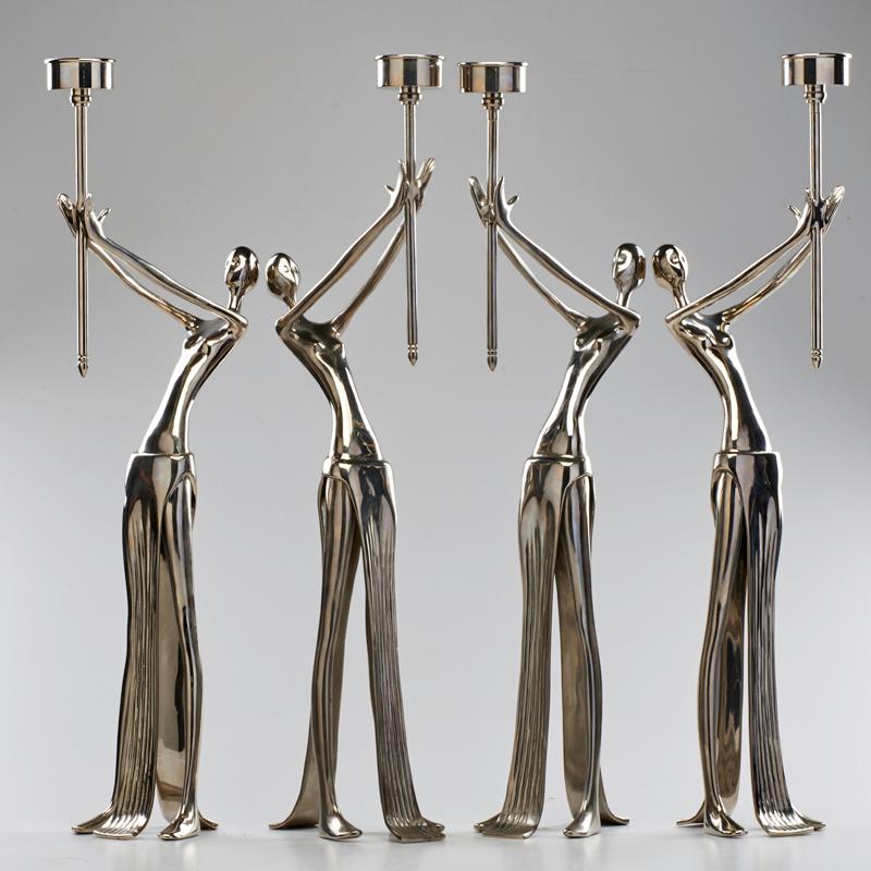 Appraisal: CONTEMPORARY Set of four figural candle holders Chromed steel Unmarked