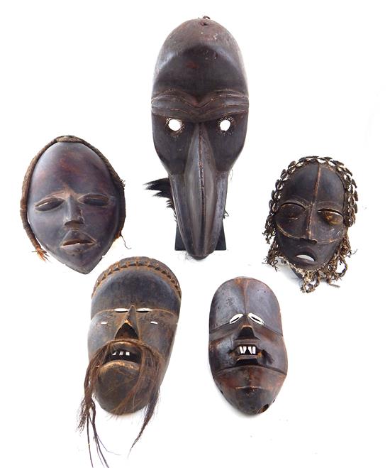 Appraisal: TRIBAL Five carved African masks Dan tribe Executioner's mask black