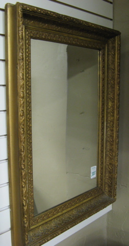 Appraisal: AN AMERICAN RECTANGULAR WALL MIRROR the curved wide frame in