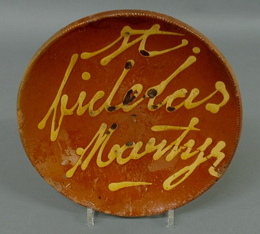 Appraisal: Rare Pennsylvania redware plate with slip decoration St Fidelas Martyr