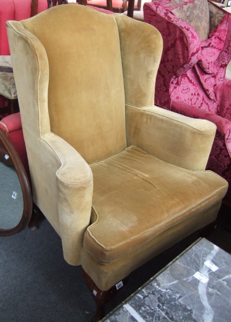 Appraisal: An early th century style shaped wing back armchair raised