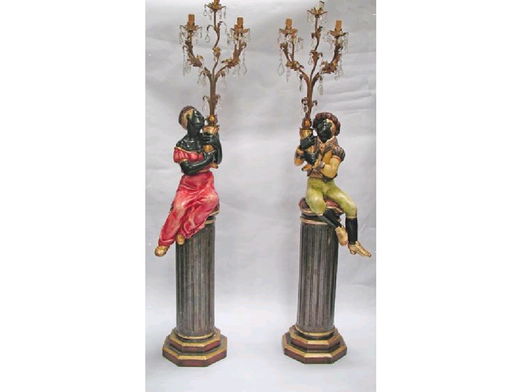 Appraisal: A PAIR OF BLACKAMOOR TORCHERES each modelled as a figure