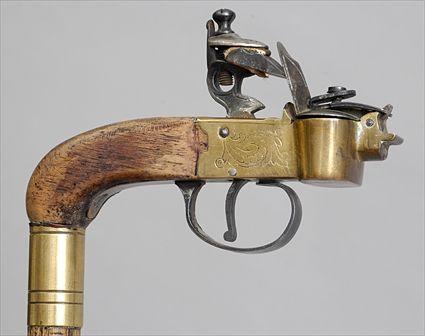 Appraisal: PISTOL-HANDLED WALKING STICK The walnut stock with engraved brass plate