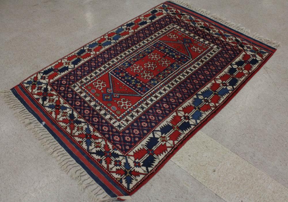 Appraisal: HAND KNOTTED TURKISH AREA RUG central panel design braided tassel