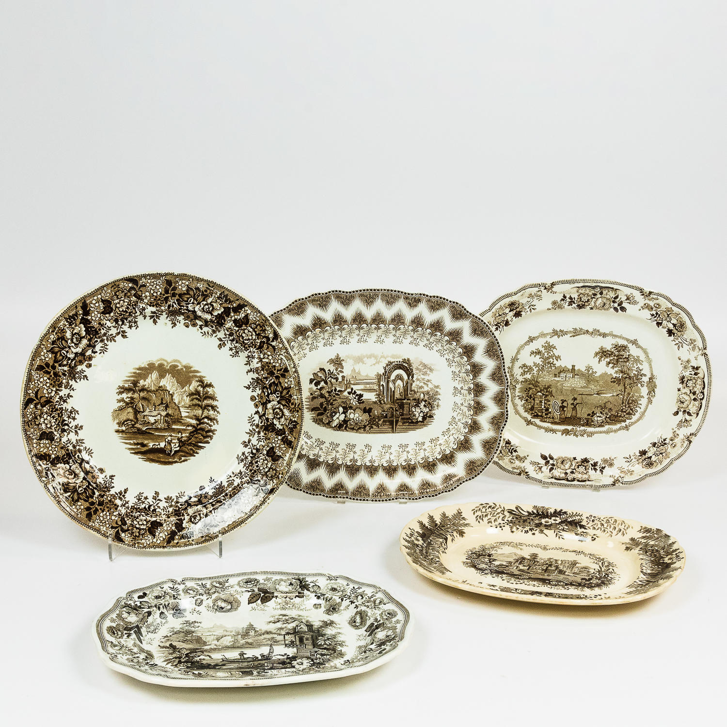 Appraisal: FOUR BROWN ENGLISH TRANSFER-DECORATED PLATTERS AND LARGE CHARGER th century