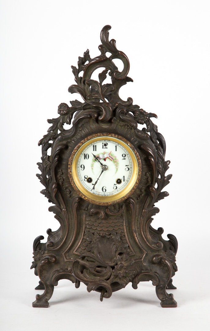 Appraisal: Rococo style patinated cast-iron mantel clock late th century enameled