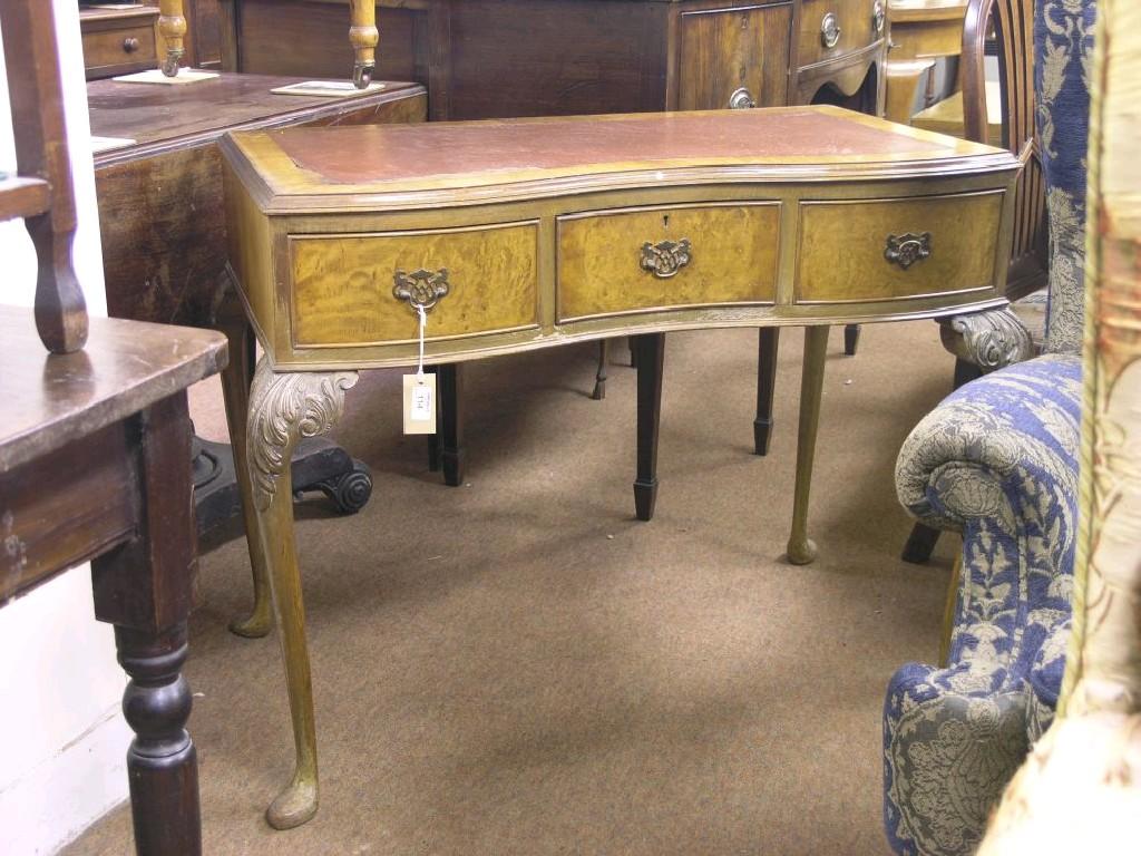 Appraisal: A burr walnut veneered writing table inverted serpentine-shape with inset