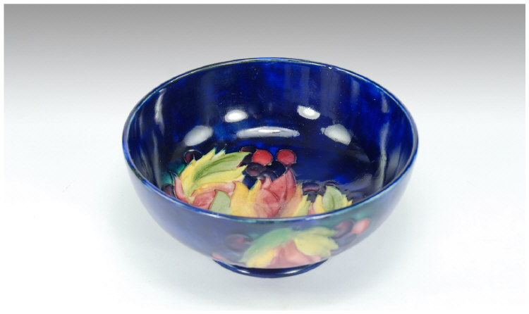 Appraisal: Moorcroft Leaf and Berry Design Footed Bowl on royal blue