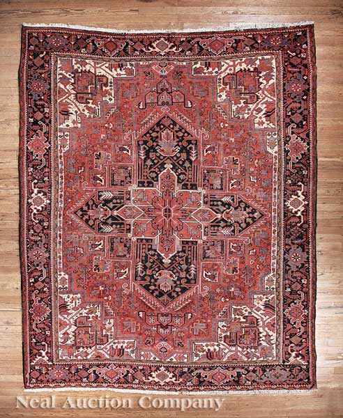 Appraisal: A Persian Heriz Carpet crimson ground large central geometric medallion