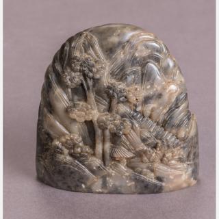 Appraisal: A Chinese Carved Grey Soapstone Boulder Depicting a Mountain Landscape