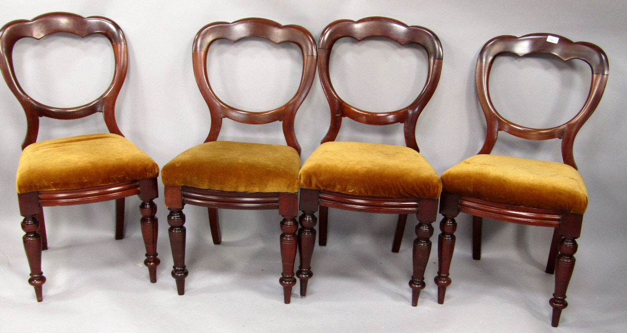 Appraisal: A set of four Victorian walnut balloon back dining chairs