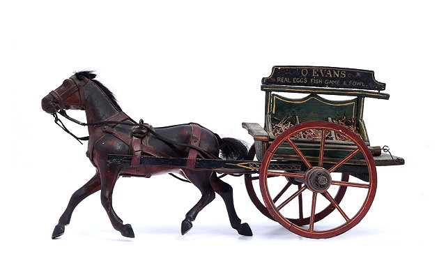 Appraisal: AN ANTIQUE MODEL GROCERS CART AND PONY the cart with