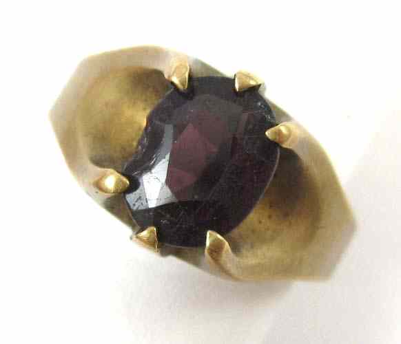 Appraisal: GARNET AND TEN KARAT GOLD SOLITAIRE RING set with an