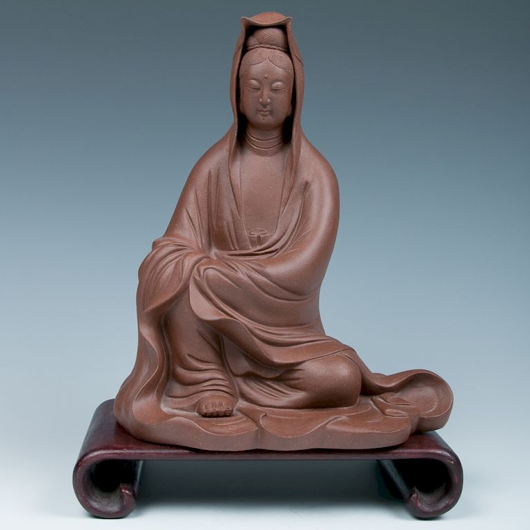 Appraisal: A ZISHA GUANYIN STATUE WITH STAND The Goddess of Mercy