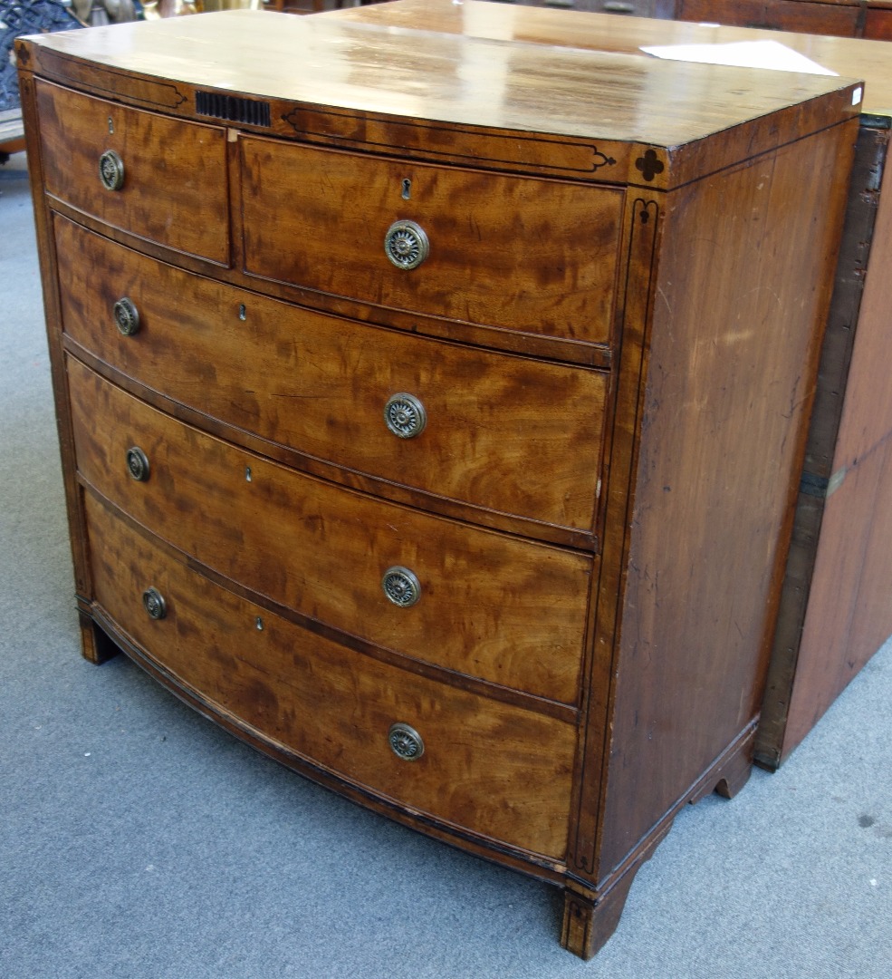 Appraisal: A George IV inlaid mahogany bowfront chest of two short