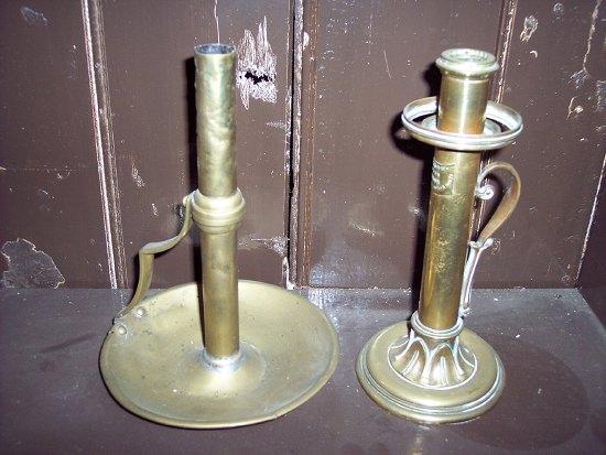 Appraisal: A brass candle holder by Palmer Co with scroll handle