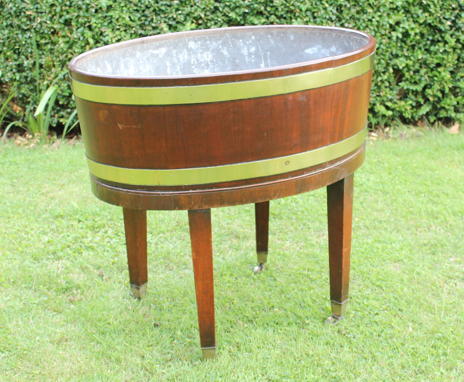 Appraisal: A George III oval mahogany wine cooler with brass banding