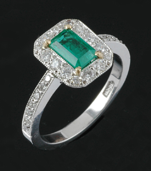 Appraisal: An emerald and diamond ring The octagonal shaped cluster centrally