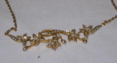 Appraisal: A LATE VICTORIAN NECKLET the five flowerheads linked by scrolls