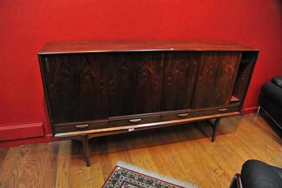 Appraisal: A DANISH ROSEWOOD SIDEBOARD with four sliding doors above four