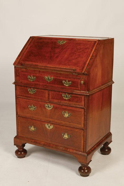 Appraisal: A GEORGE I WALNUT BUREAU in the manner of Coxed