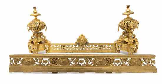 Appraisal: A Neoclassical Gilt Metal Fire Guard comprising two chenets and