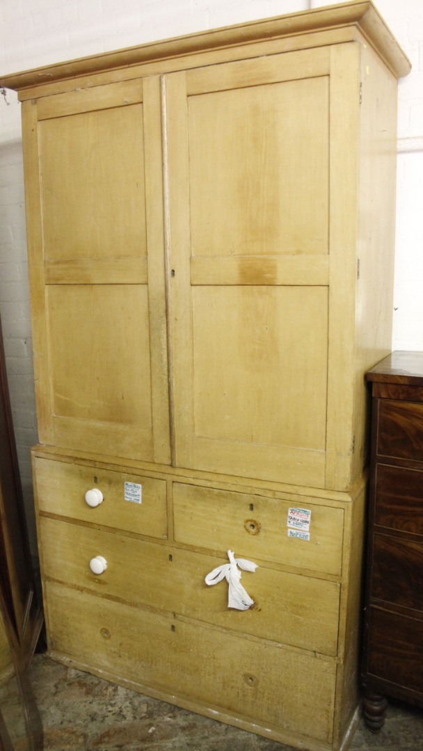 Appraisal: A Victorian pine linen press the overhanging cornice raised above