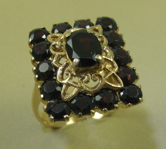 Appraisal: GARNET AND EIGHTEEN KARAT GOLD RING the rectangular setting centering