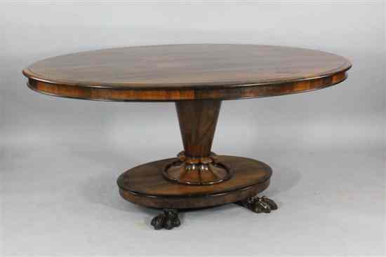 Appraisal: A Victorian rosewood breakfast table with oval top and claw