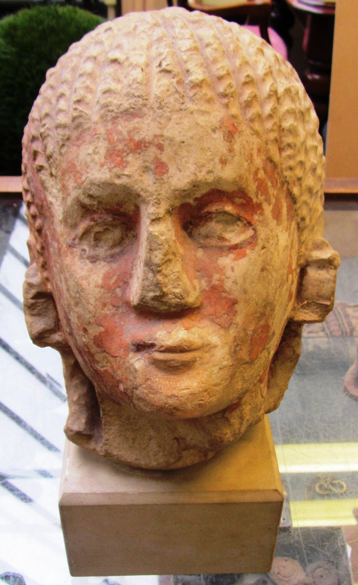 Appraisal: A large limestone male head with original crimson pigment remaining