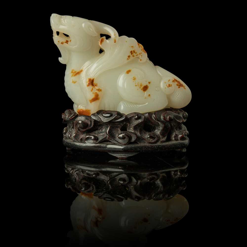 Appraisal: WHITE JADE WITH RUSSET SKIN CARVING OF A MYTHICAL WINGED