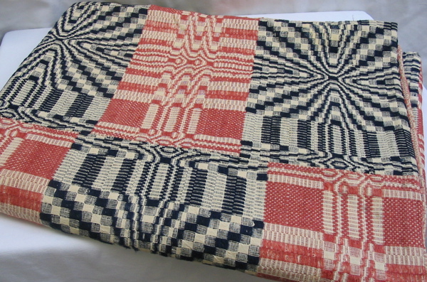 Appraisal: AN AMERICAN JACQUARD COVERLET hand loomed blue and red blocks