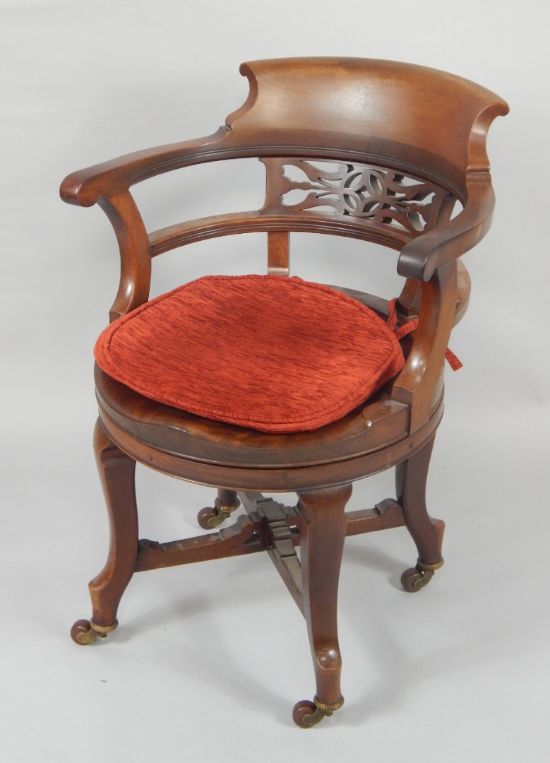 Appraisal: A Victorian mahogany revolving office chair with fretwork back rail