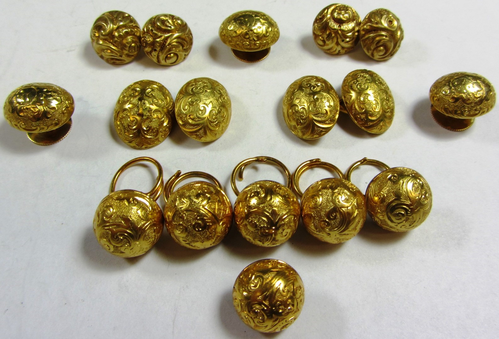 Appraisal: A set of six hemispherical dress buttons with scroll engraved