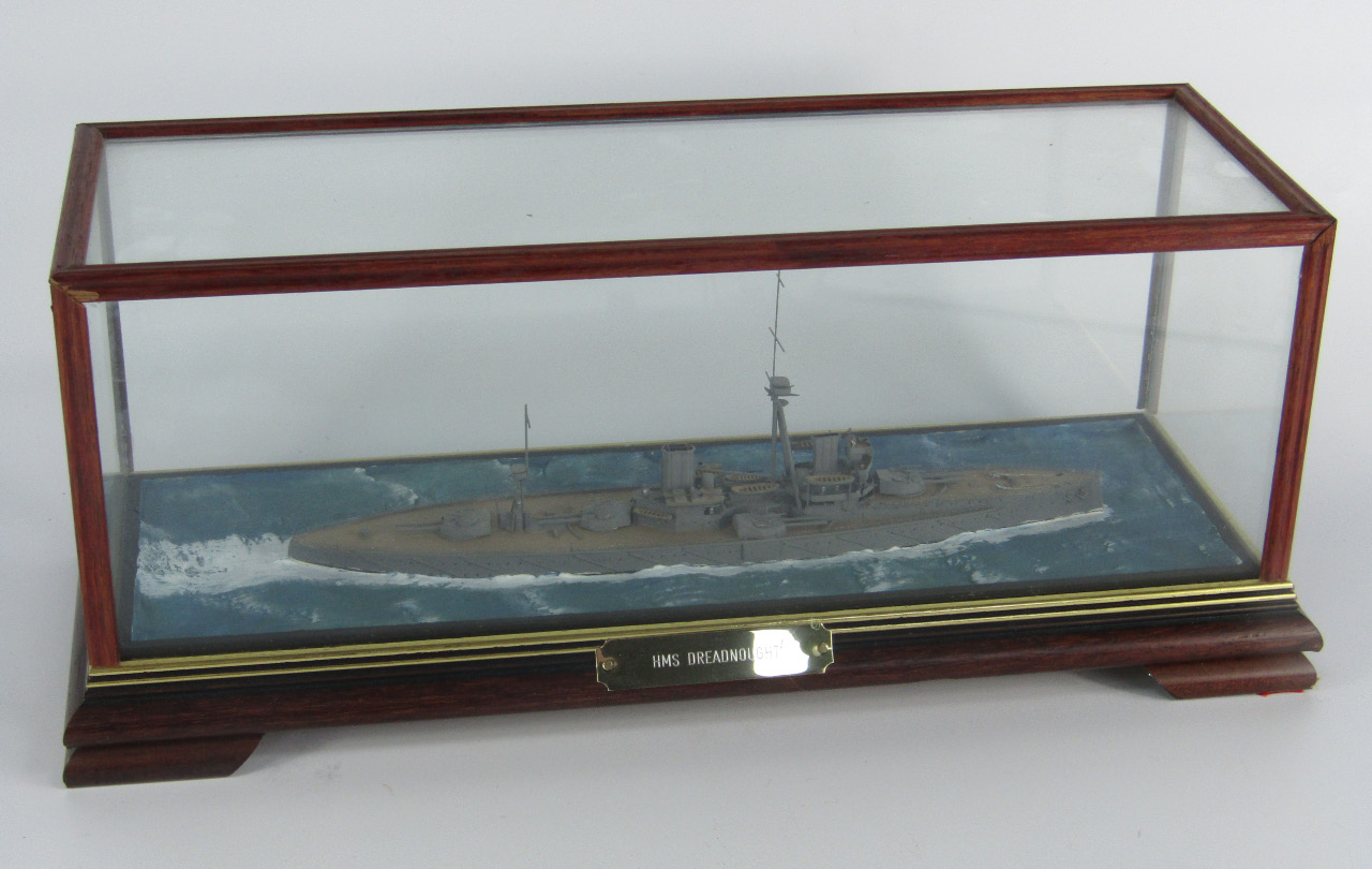 Appraisal: A scale model of the battleship HMS Dreadnought cased with