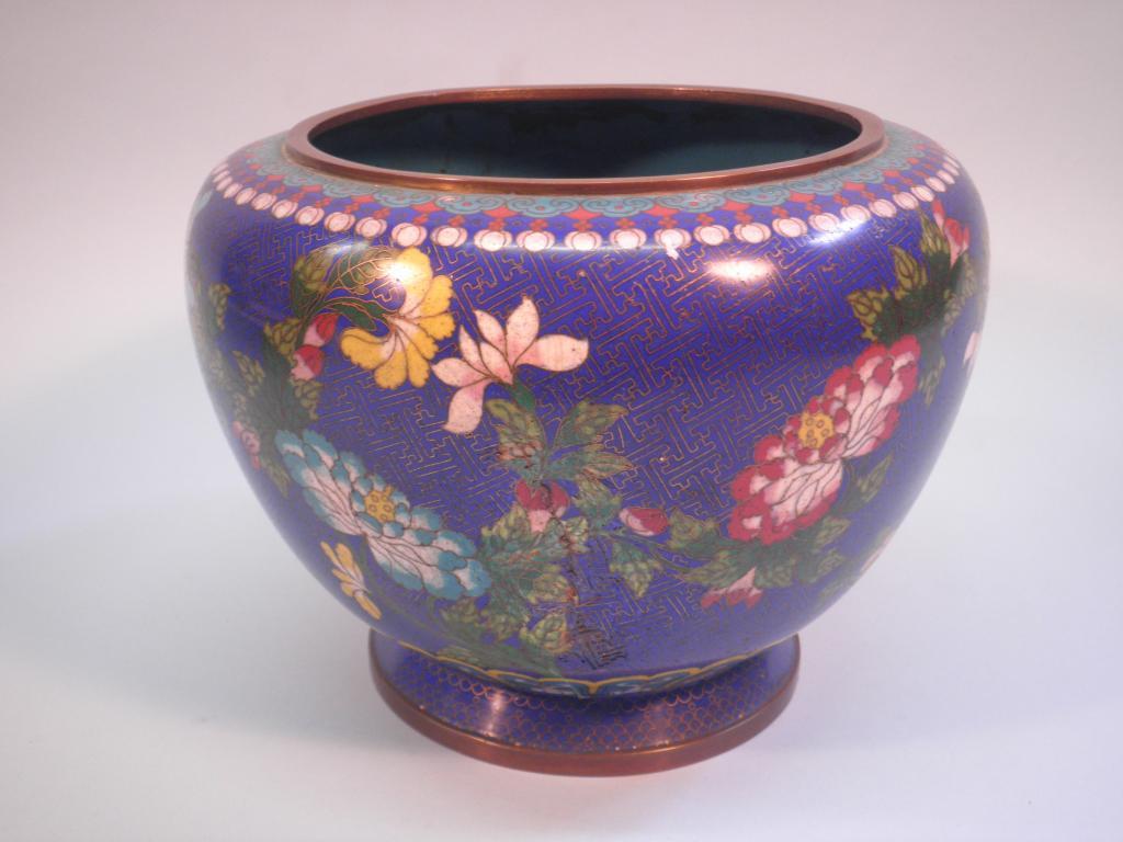 Appraisal: A Japanese cloisonne jardiniere decorated with flowers on a pale