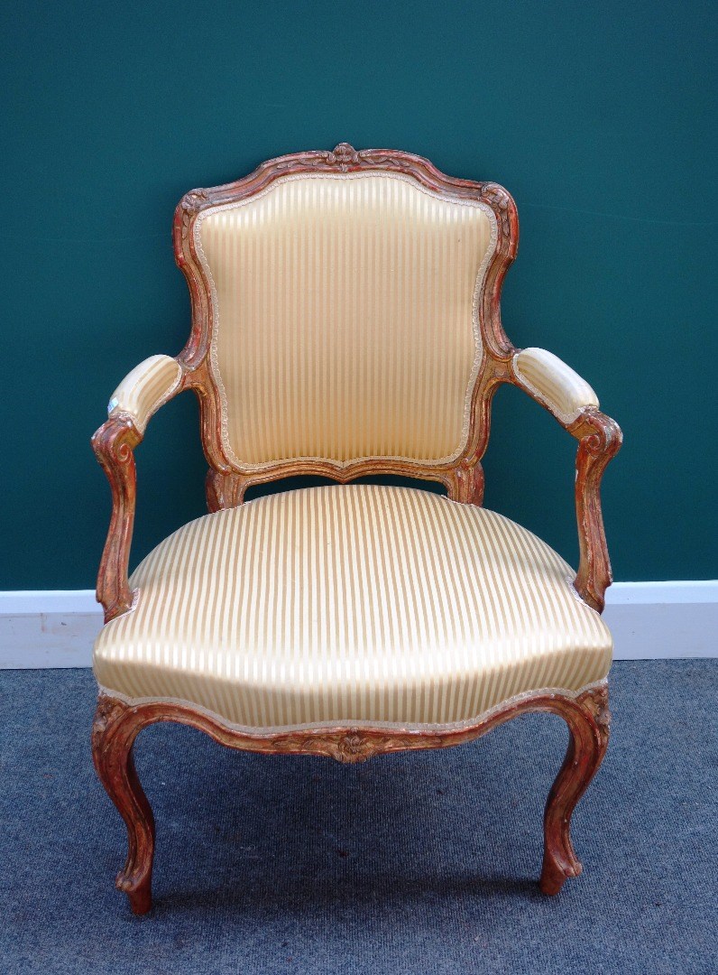 Appraisal: An th century French gilt framed open arm fauteuil with