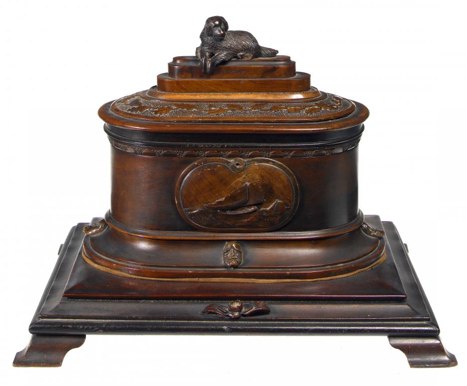 Appraisal: A VICTORIAN WALNUT BOW ENDED JEWEL CASKET the lid carved