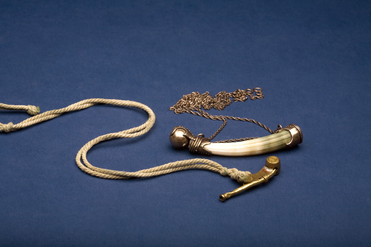 Appraisal: SILVERED BRASS AND CARVED SHELL BOSUN'S WHISTLE ON CHAIN TOGETHER