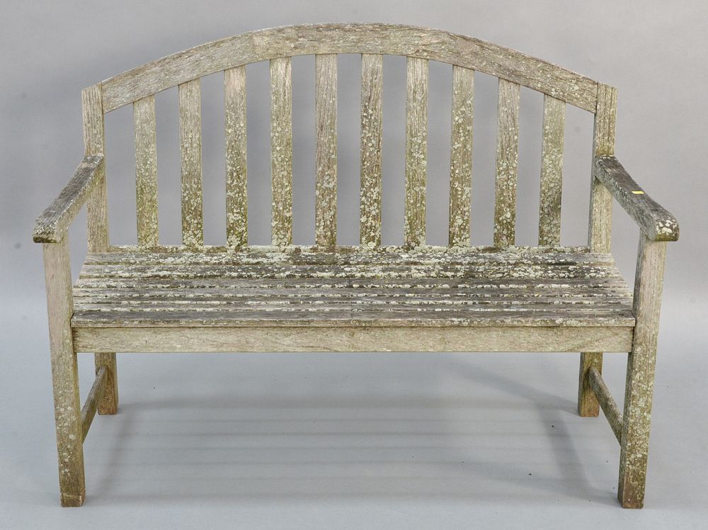 Appraisal: Teak outdoor bench having arch top Teak outdoor bench having