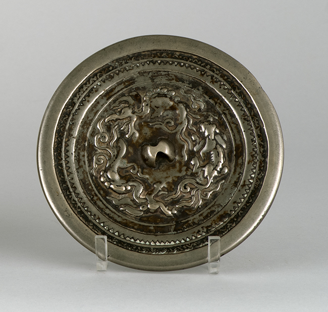 Appraisal: SILVERED-BRONZE MIRROR Ming DynastyWith relief dragon and lion design within