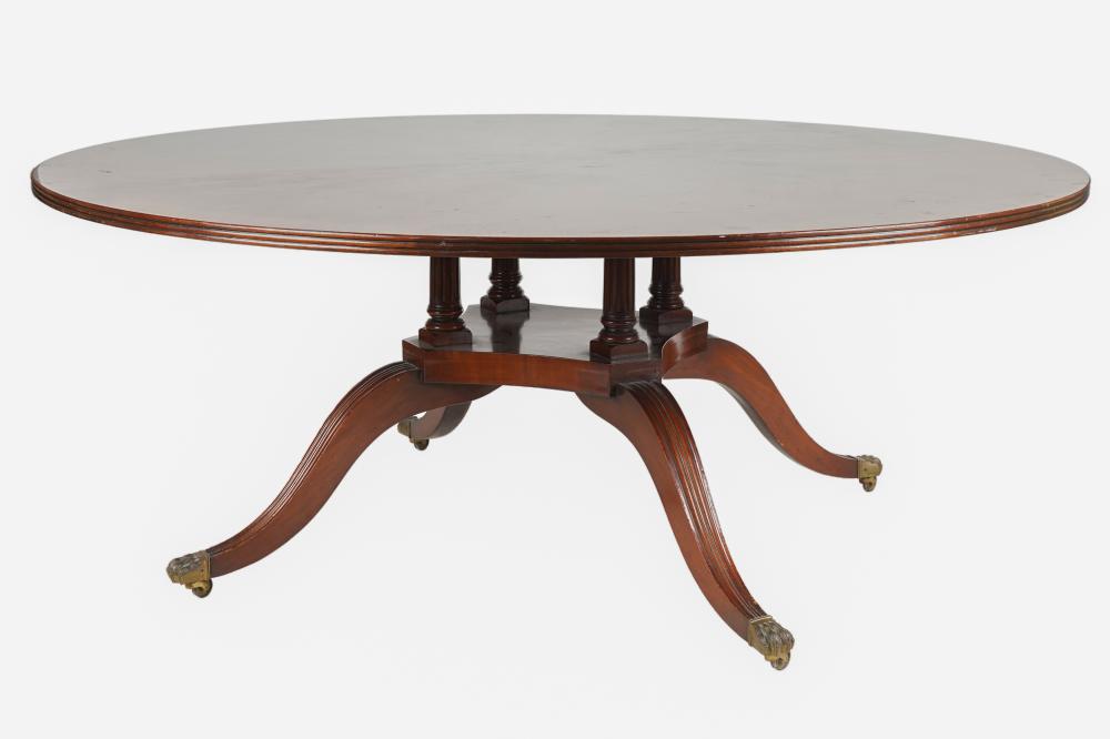 Appraisal: REGENCY STYLE MAHOGANY DINING TABLE th century with round cross-banded