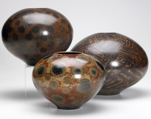 Appraisal: PARADOX POTTERY Three spherical vessels each covered in a unique