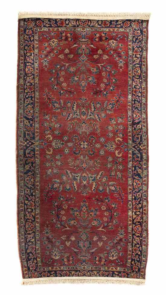 Appraisal: A Sarouk Wool Rug having floral decoration on a red